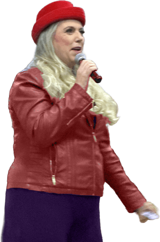 Michelle Lee walking a stage in a red hat and a red leather jacket, speaking into a microphone