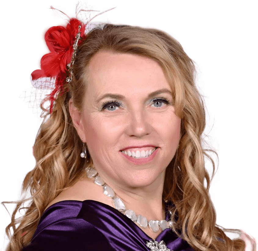 Michelle Lee smiling, in a red feathered fascinator, a pearl necklace and a purple satin dress